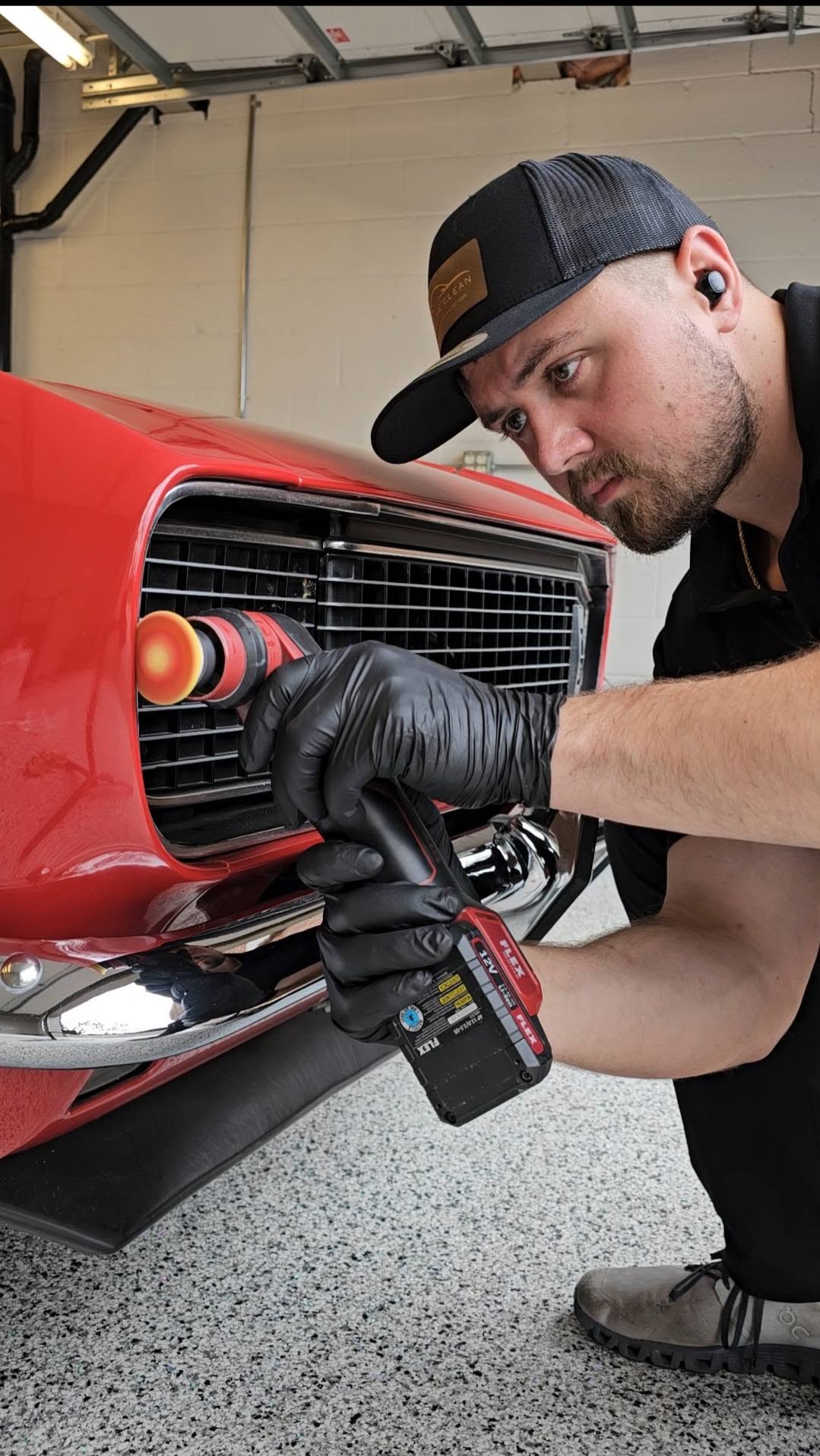 Pristine Clean technician refining the gloss on a classic red vehicle