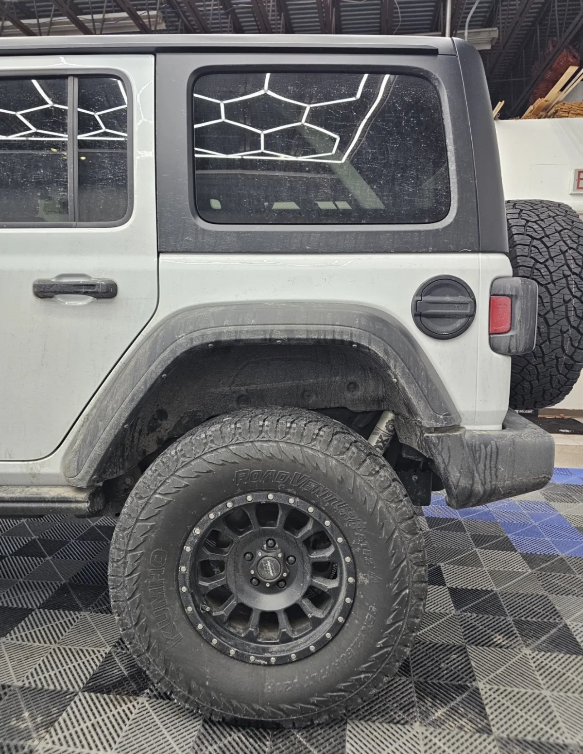 Jeep wheel well and rear quarter before winter salt cleanup