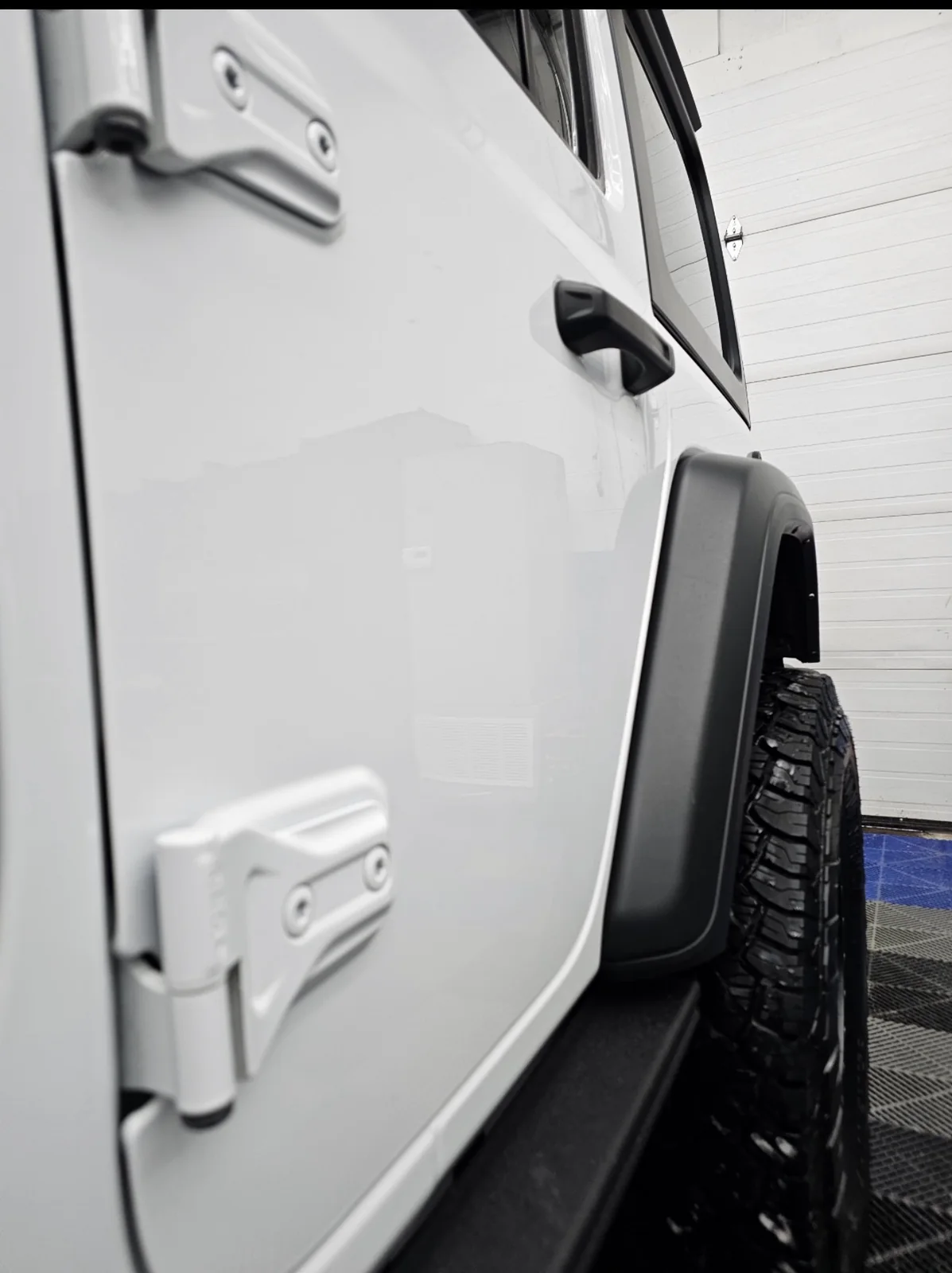 Clean Jeep door, hinge and lower panel after winter cleanup